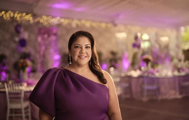 A woman in a purple dress smiling at a party