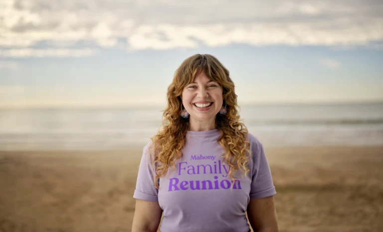 Woman standing in field with a shirt that reads Mahoney Family Reunion