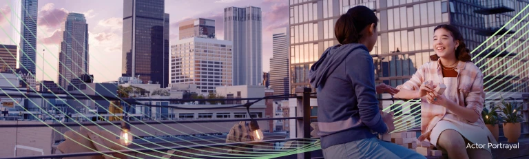 Two women talking on top of a rooftop